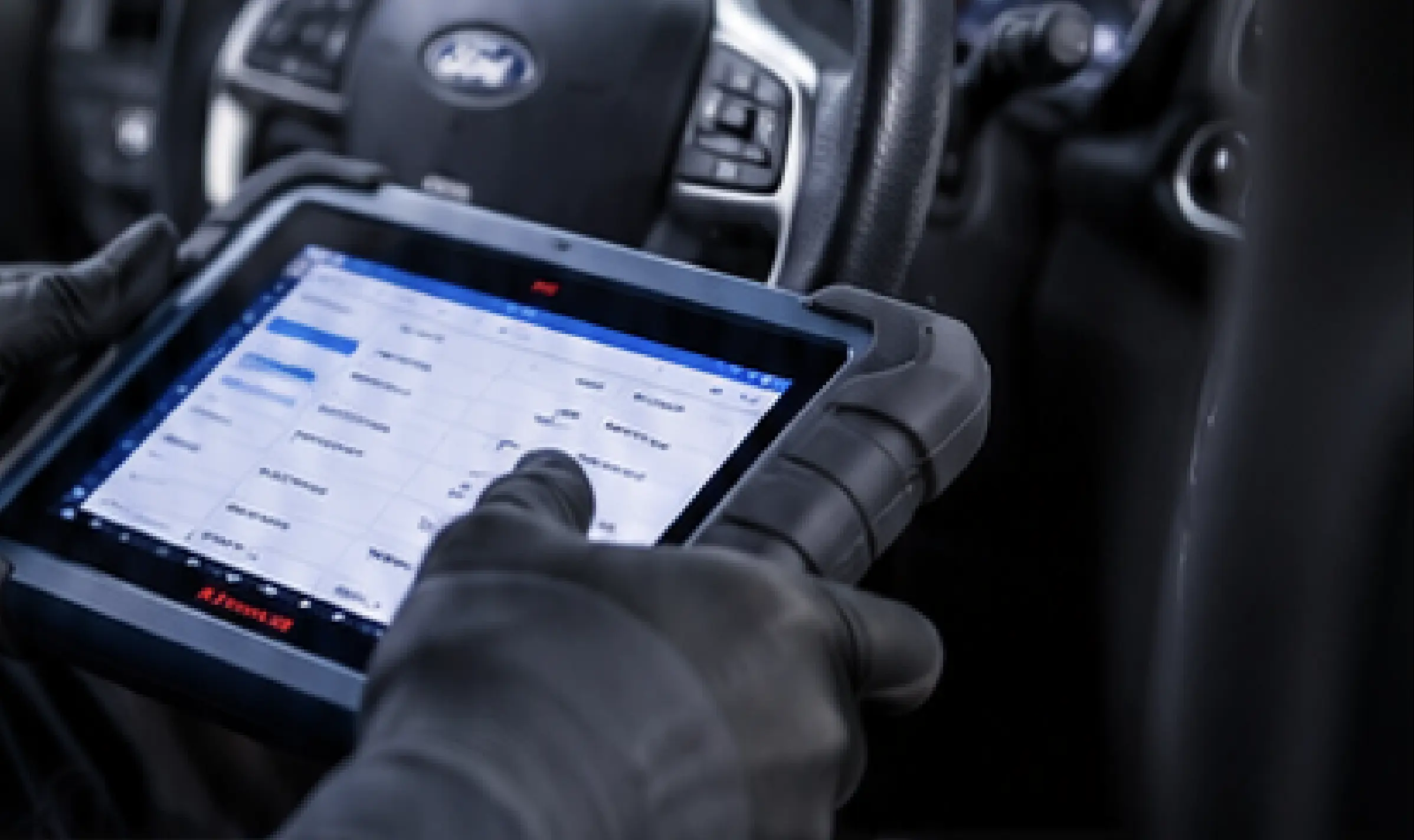 A technician performing diagnostic tests inside a car.