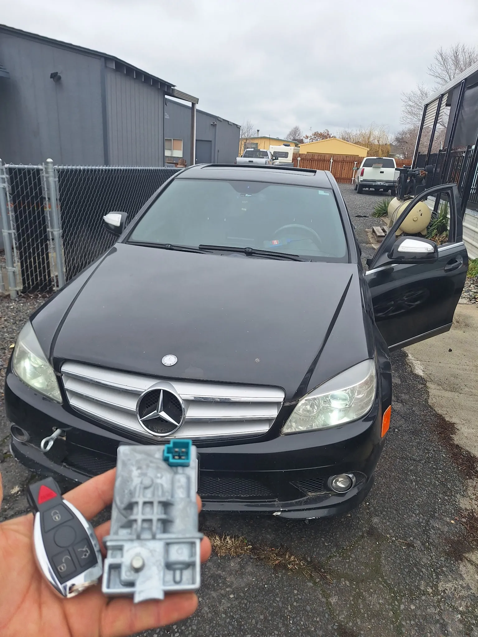 A key in front of a Mercedes-Benz.