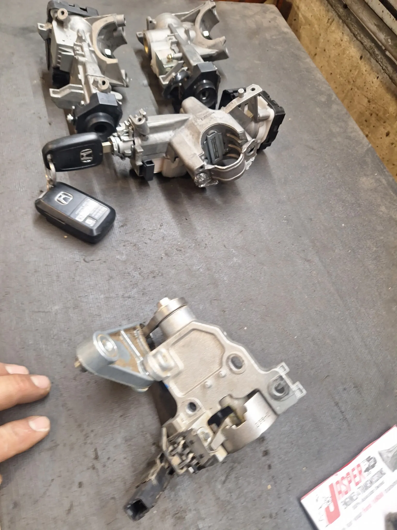 Disassembled ignition components and a Honda vehicle key.