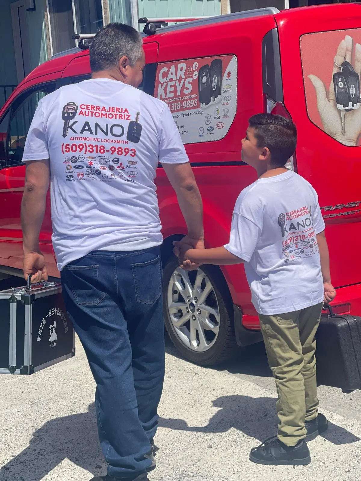 Father and son wearing Kano Automotive Locksmith apparel.
