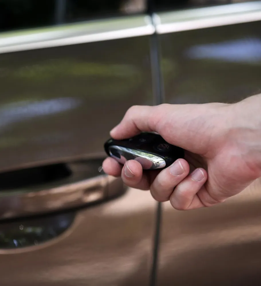 An image of a person unlocking a vehicle.